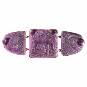 Purple carved stone bracelet with three linked panels; central square and two heart-shaped end pieces.