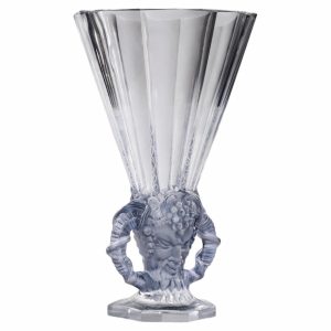 Crystal vase with a fluted top and a sculpted humanoid figure at the base supporting the bowl, made of clear glass/crystal.