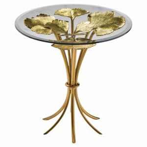Gold-toned metal pedestal side table with a round glass top and leaf-shaped ornamentation at the base and top.